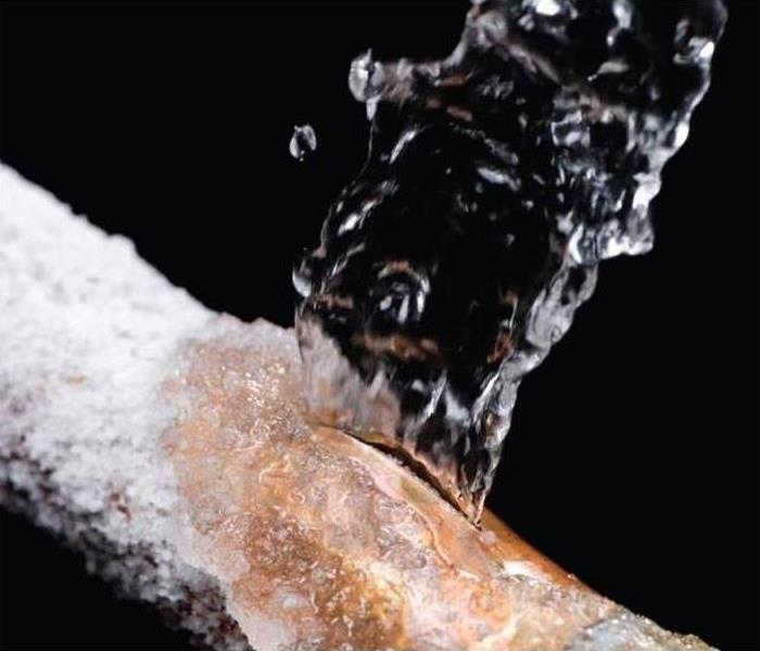 A pipe that has broken due to freezing temperatures is shown spraying water.